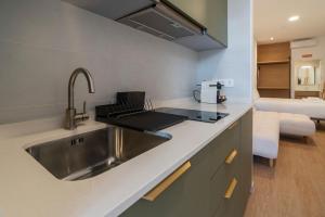 a kitchen with a stainless steel sink and a room at VLC HOST - Molinell in Valencia