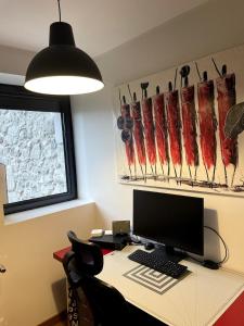 an office with a desk with a computer on it at Villa au calme avec piscine in Saint-Ismier