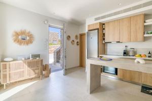 a kitchen with a counter top and a refrigerator at Villa Gypsea - Paros in Aspro Chorio Paros +12 photos