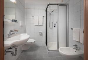 a bathroom with a toilet and a sink and a shower at Hotel Sureghes in Ortisei +14 photos