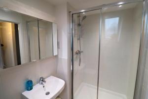 a bathroom with a shower and a sink at High Wycombe Stunning Stylish Four Bedroom House in High Wycombe