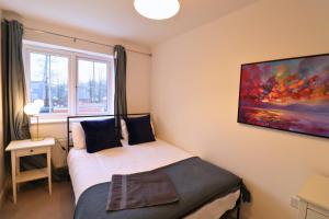 a small bedroom with a bed and a window at High Wycombe Stunning Stylish Four Bedroom House in High Wycombe