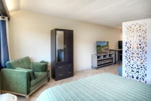 a bedroom with a bed and a chair and a mirror at Tamarron Lodge Studio 343 in Durango +42 photos
