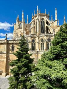 a large cathedral with two trees in front of it at Suites La Catedral in León