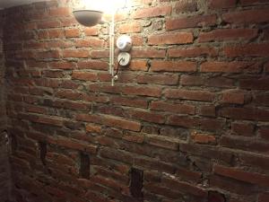 a brick wall with a security light on it at Suites La Catedral in León