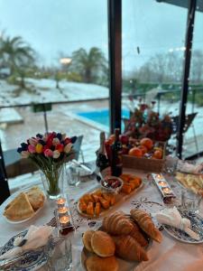 a table with bread and pastries on it with a view at Panorama Sormoni in Dzhimastaro