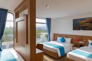 a hotel room with two beds and a window at Yen Hotel in Tuy Hoa