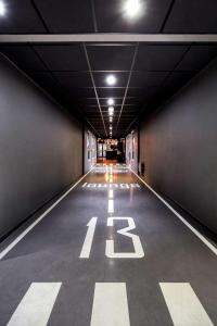 a long hallway with the number painted on the floor at Pentahotel Brussels Airport in Diegem +30 photos