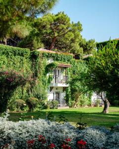 Un edificio cubierto de hiedra en un jardín. en Club Marco Polo - Premium All Inclusive, en Kemer 71 fotos más