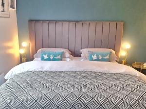 a bedroom with a large bed with two pillows at No 12 B&B in Dungarvan