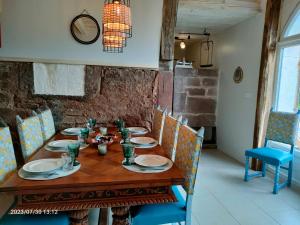 a wooden table with chairs and a dining room at home edwige in Fresse