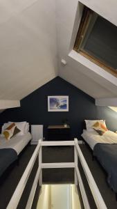 a room with two beds and a balcony at Cosy 3 Bedroom, 5 Bed House! in Headingley