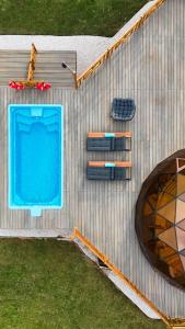 an overhead view of a swimming pool and two chairs at Al Marmoom Oasis Luxury Experiential Desert Resort in Dubai +6 photos