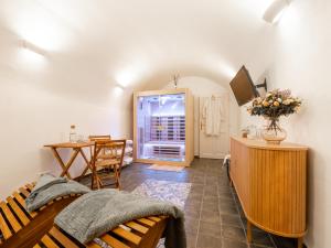a living room with a bed and a desk and a table at Křišťanka - kouzelné apartmány in Prachatice