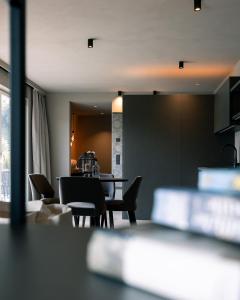 a kitchen and dining room with a table and chairs at Belia Lofts - ADULTS ONLY - Apartments in Appiano sulla Strada del Vino