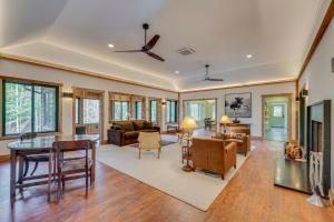 a living room with a ceiling fan and a table at Riverfront Hideaway in Keene Walk to Town! in Keene