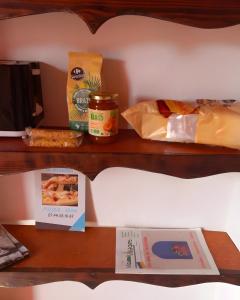 a shelf with bread cheese and other food items on it at Le Belvedeou - Mercantour in Belvédère