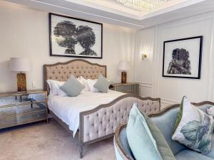a bedroom with a large bed and a couch at Lira Boutique Lodge in Thohoyandou +143 photos