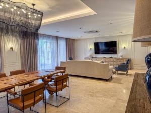 a living room with a couch and a table and chairs at Lira Boutique Lodge in Thohoyandou