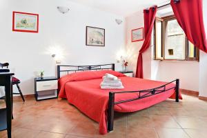a bedroom with a red bed and a window at Ada's guest house in Bosa