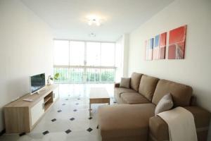 a living room with a couch and a table at Mansión Alhamar Beachfront in Sitio de Calahonda