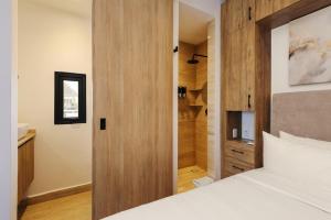 a bedroom with a bed and a wooden door at Casa Colón by Wynwood House in Mexico City +123 photos