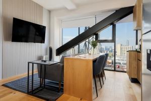 a living room with a table and a large window at Casa Colón by Wynwood House in Mexico City