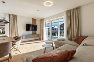 a living room with a couch and a table at Alpine Suite Spot in Bad Mitterndorf