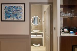 a bathroom with a sink and a mirror at Le Robinet d'Or Paris Canal Saint Martin in Paris +58 photos