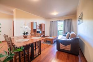 a living room with a table and a couch at TMaria in Ponta do Sol