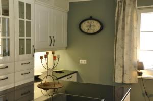 a kitchen with a clock on the wall at das stille Paradies in Ledenitzen +35 photos