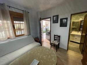 a living room with a white couch and a table at Casa para parejas El Cerrillo in Castril