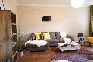 a living room with a couch and a table at Stylish New City Appartement in Graz