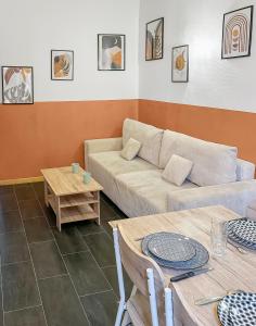 a living room with a couch and a table at Havre de Paix avec Jardin Privé in Angoulême +12 photos