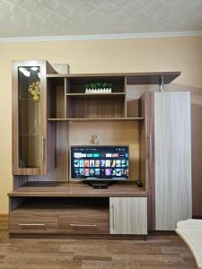 a large entertainment center with a flat screen tv at Lux Apartment on Potanina 19 in Ustʼ-Kamenogorsk