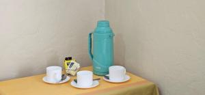 a blue water bottle sitting on top of a table with cups at Hotel Cristobal Colon in La Serena