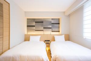 Postel nebo postele na pokoji v ubytování Nishitetsu Hotel Croom Hakata