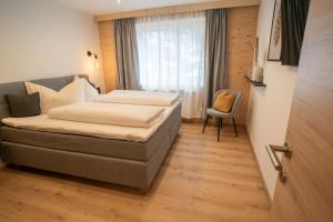 a hotel room with a bed and a window at Apartement Waldfrieden in Pfons