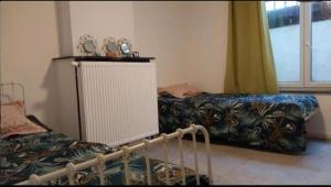 Ένα ή περισσότερα κρεβάτια σε δωμάτιο στο Chambre 2lit célibataire schaarbeek sous-sol