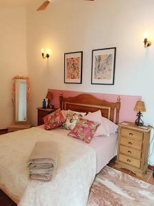 a bedroom with a bed and a dresser and a mirror at La Biznaga - Comares in Comares