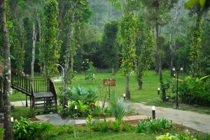 a park with a bench in the middle of a field at ALLISON the Tribe Resort in Mananthavady