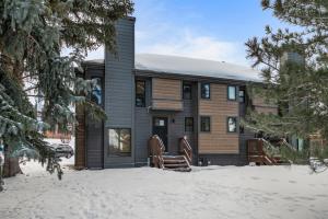 a house in the snow with chairs in front of it at Hidden Creek by Park City Vacations in Park City