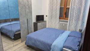 a bedroom with a bed and a television in it at La Torretta Asti in Asti