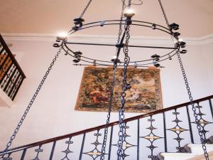 a chandelier hangs from the staircase of a home at Leasowe Castle Hotel in Moreton