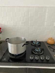a pot on top of a stove in a kitchen at Malka Casas - Hoteles in Marco
