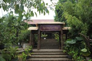 a sign that says anything for things in a garden at Nhà sàn cộng đồng in Thanh Sơn