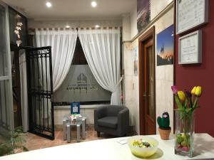 a living room with a chair and a table at Hostal Santa Barbara in Toledo