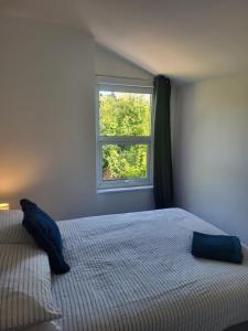 a bedroom with a bed and a window at Seaside 3 Bedroom Home in Ramsgate