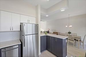 a kitchen with a refrigerator and a dining room at Coastal waterfront condo located in Olde Marco in Marco Island +22 photos