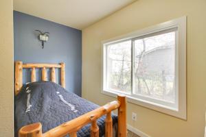 a bedroom with a bunk bed and a window at Quaint Ironton Getaway with Fire Pit, Gas Grill! in Ironton